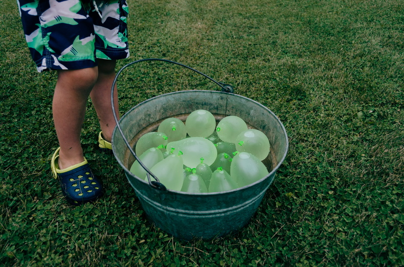 food and drink, gray, stainless, beside, body part, boy, bucket, outdoors, leisure activity, grass, shark, garden, green color, real people, day, nature