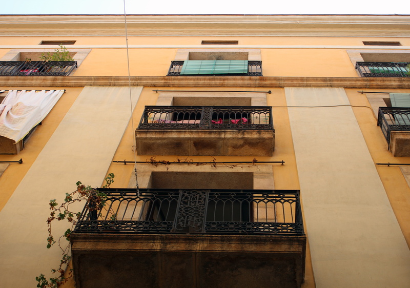 building, home, built structure, low angle view, facade, old, yellow, staircase, day, architecture, glass - material, modern, barcelona, no people, potted plant