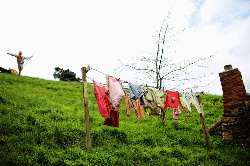 hanging, the hobby, the shire, field, built structure, ring shot, no people, low angle view, drying, matamata, building exterior, building, new zealand