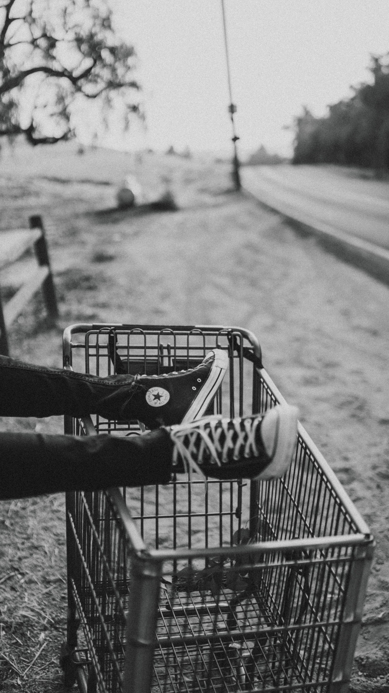 grayscale, black and white, foot, trainer, photo, focus on foreground, road, person, transportation, plant, footwear, selective focus, lake, lifestyles