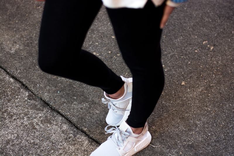 day, human leg, shoe, jeans, human limb, sunlight, sneakers, street, standing, united states, city, body part, one person, shoes, lifestyles, shadow, fashion