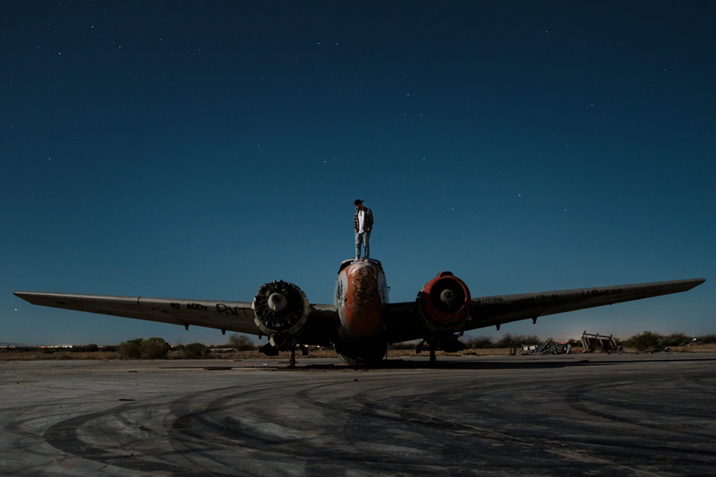 real people, dark blue sky, transportation, hat, united states, light, sky, sitting on plane, bomber, copy space, orange, airplane, airport, skyline#, grey