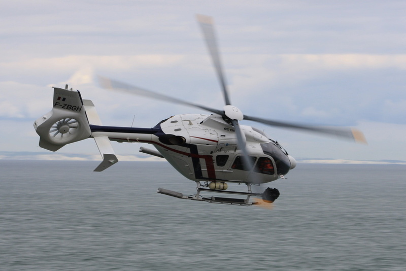 mid-air, no people, speed, cloud - sky, transportation, air vehicle, side view, airbus ec 135, mode of transportation, motion, navy, helicopter, military