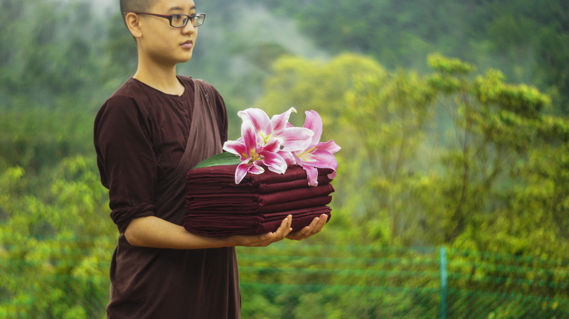 flower, standing, waist up, focus on foreground, buddhism, freshness, front view, robe and flower, Nun, real people, monks robe, leisure activity, Robes