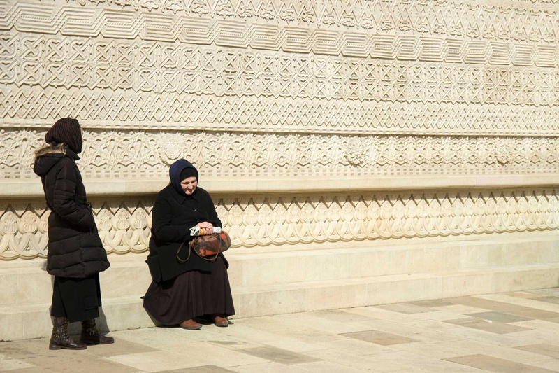 warm clothing, lifestyles, communication, people, two people, built structure, Nuns, young women, clothing, Church, real people, sitting, emotion, togetherness