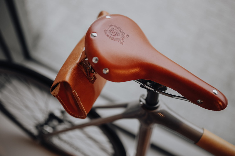music, retro, transportation, arts culture and entertainment, studio shot, orange color, bike, leather, focus on foreground, ornate, vintage, art and craft