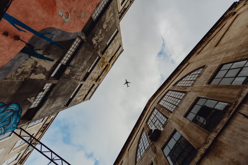 outdoors, built structure, low angle view, animals in the wild, day, lisbon, flying, hipster, vertebrate, lx factory, animal, cloud - sky, architecture