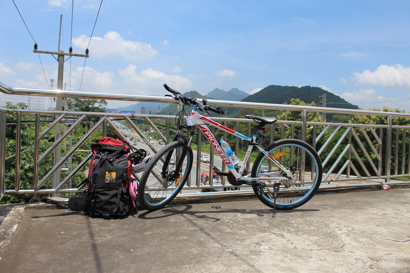 cloud - sky, wheel, outdoors, outdoor, helm, bicycles, bag, stationary, nature, transport, beauty in nature, sunlight, parking, travel, land, jungle, scenics - nature