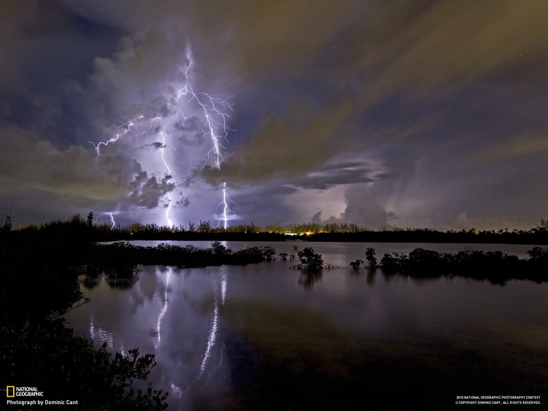 illuminated, storm, no people, power, storm cloud, thunderstorm, beauty in nature, lightning, lake, water, nature, power in nature, sky, National Geographic
