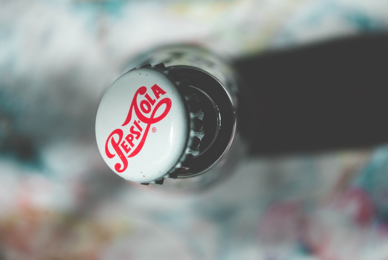red, circle, bottle, day, outdoors, capital letter, focus, communication, no people, cola, push button, covered, security, cap, text, glass bottle, sugary
