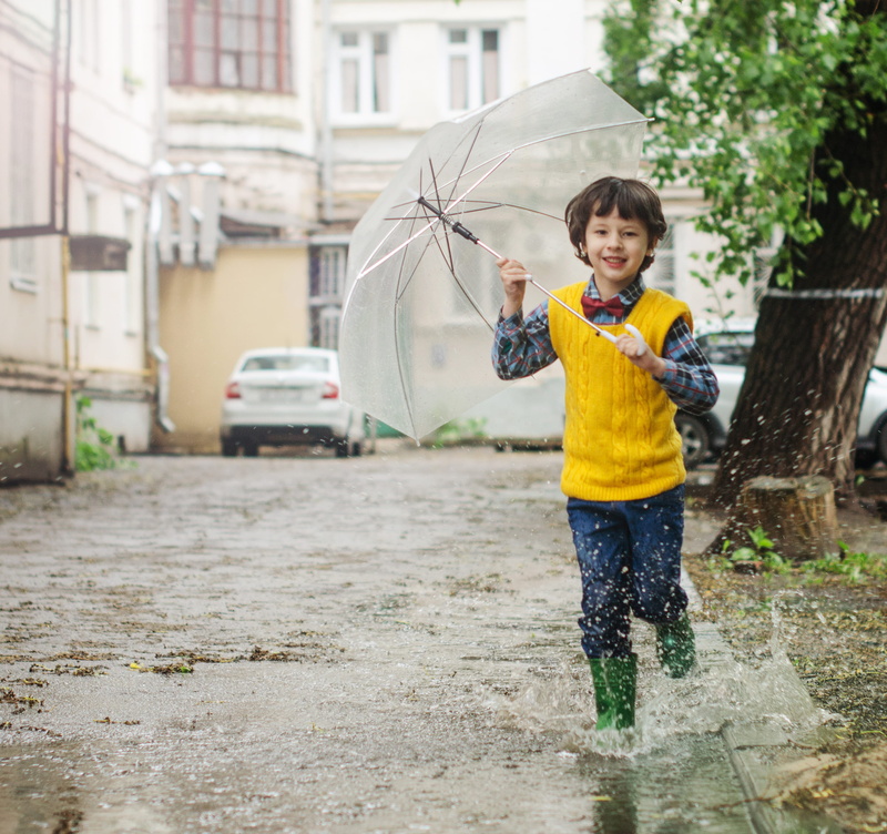 innocence, splash, running, boy, lifestyles, outdoors, childhood, fun, males, built structure, kid, 2K, umbrella, one person, arms raised, enjoyment, building exterior