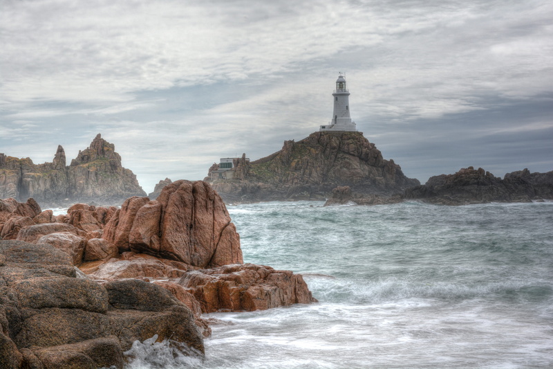 water, beauty in nature, jersey island, motion, rock formation, building exterior, sky, stack rock, rock - object, solid, 5K, lighthouse, rock, scenics - nature