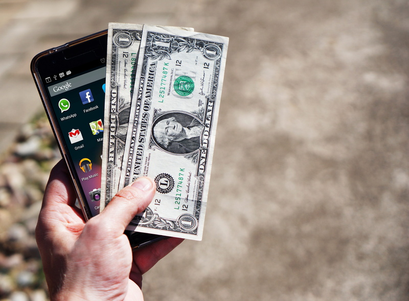 consumerism, real people, phone, money, us dollars, focus on foreground, cheap, currency, save money, wealth, black, holding, one person, close-up, person