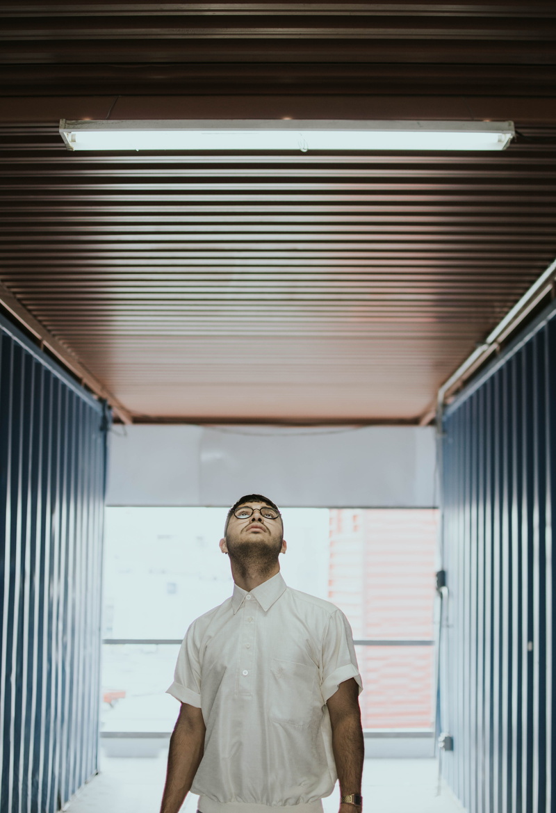 built structure, architecture, pathway, lamp, men, young men, corrugated, adult, waist up, brown, looking up, low angle view, males, indoors, ceiling, building