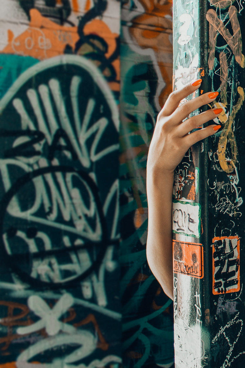 day, graffiti, body part, polish, built structure, leisure activity, paint, art, red, person, arm, architecture, female, nails, lifestyles, human body part