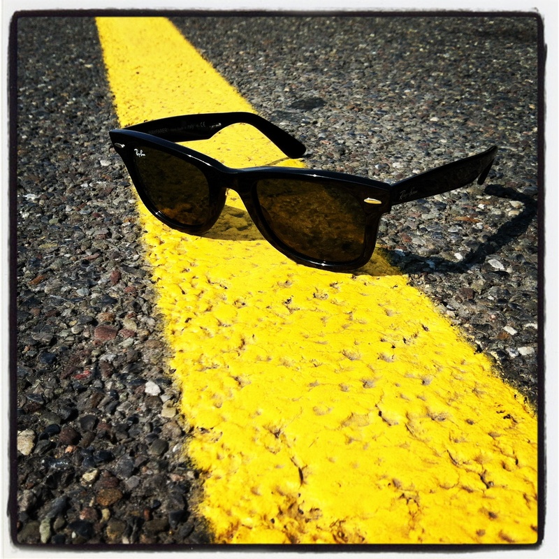 high angle view, eyewear, yellow, gravel, personal accessory, road trip, framed, ban, vacation, transfer print, holiday, wayfarer, no people, nature, tarmac
