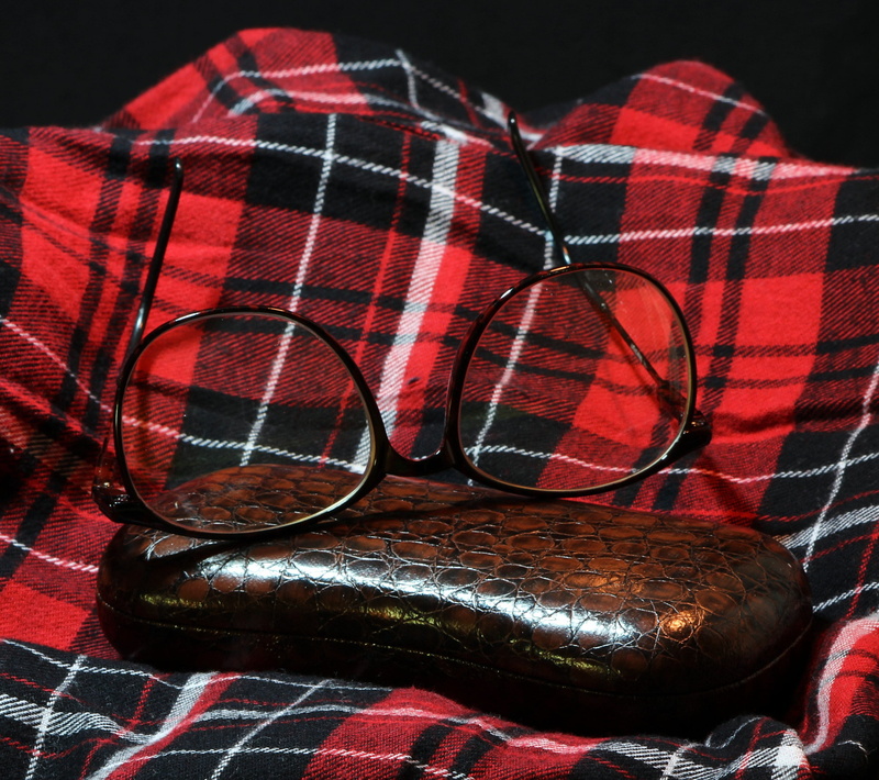bed, spectacles, furniture, eyewear, accessory, specs, checked pattern, two objects, fashion, focus on foreground, case, art and craft, vision, brown, optic