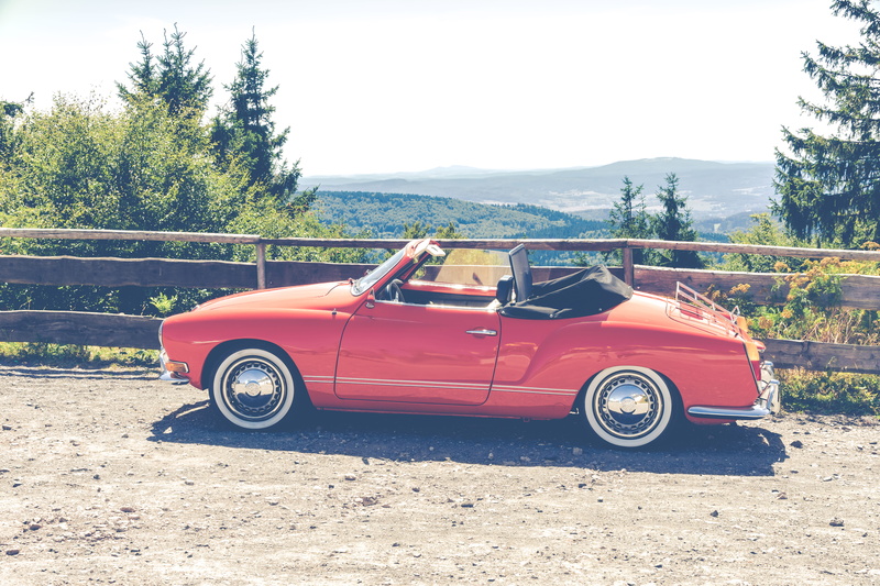 field, vintage car, coupe, motor vehicle, wheels, convertible, windshield, day, fence, near, chrome, retro styled, trees, transportation system, classic