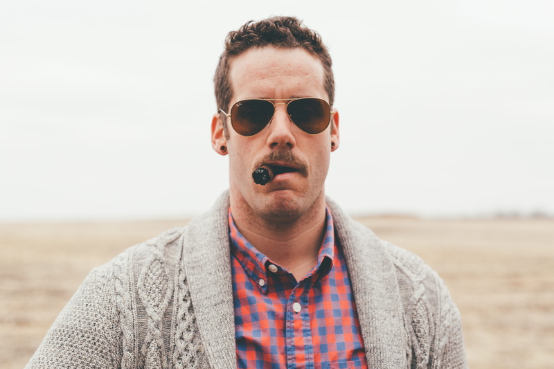 sunglasses, looking at camera, land, nature, one person, glasses, lifestyles, portrait, beard, photography, tobacco, real people, man, sky, using, waist up