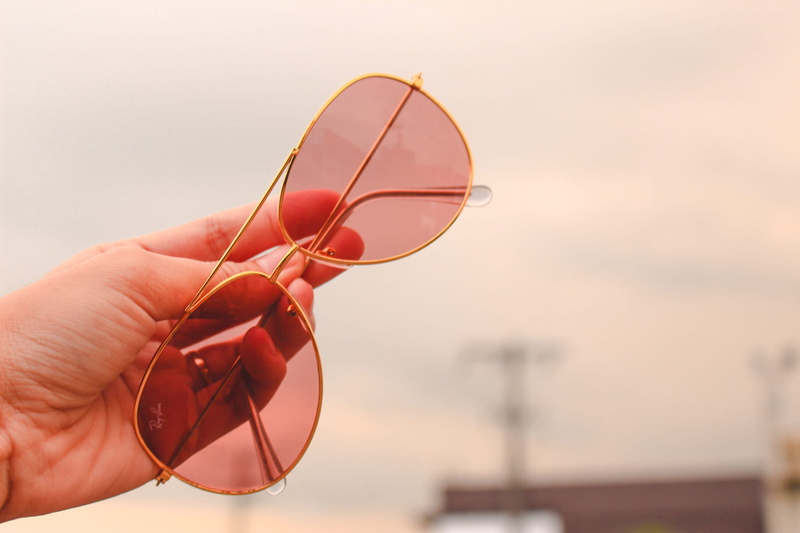 glass - material, red, human finger, RayBan, body part, hand, sunglasses, close-up, unrecognizable person, eyewear, transparent, holding, focus on foreground