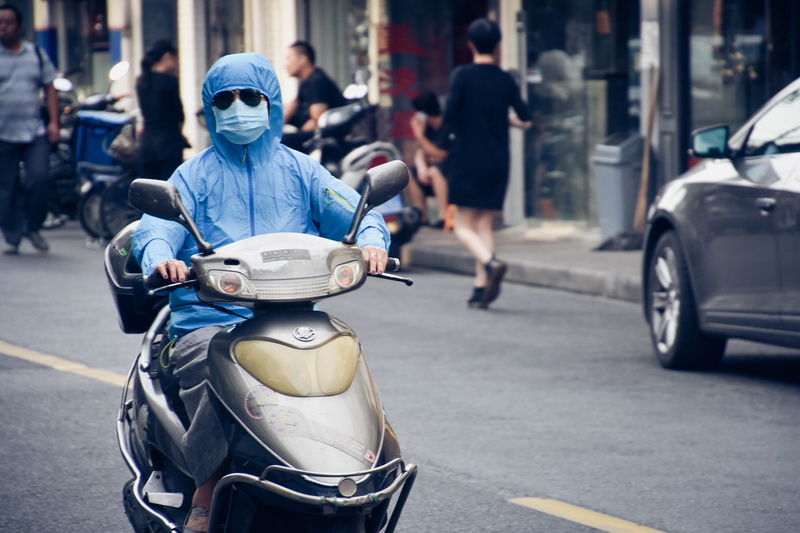 riding, city street, pollution, motor, real people, scooter, protection, outdoors, mode of transportation, rayban, driving, one person, road, street, transportation