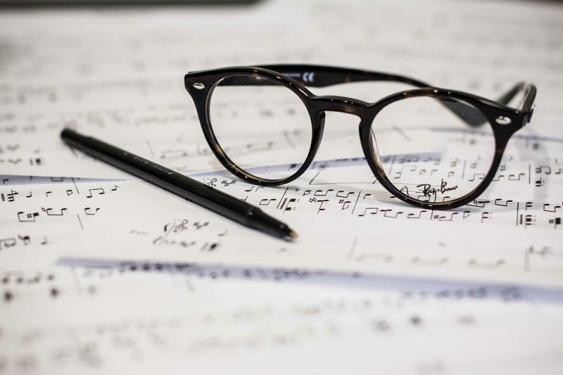 focus on foreground, eye test equipment, music, eyewear, reading glasses, still life, no people, education, indoors, close-up, studio shot, beside, black