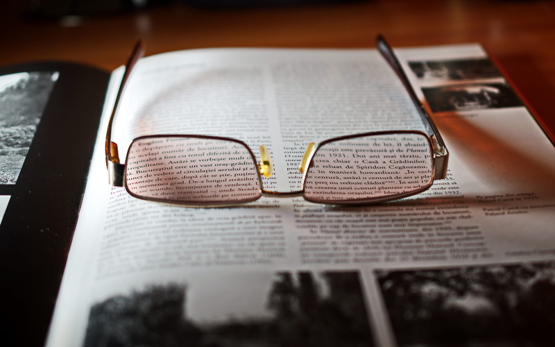 page, two objects, high angle view, selective focus, eyeglasses, open, eye glasses, newspaper, gold, publication, indoors, no people, 4K, reading glasses