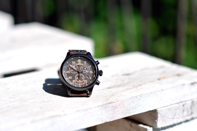 roman, selective focus, watch, wristwatch, time, close-up, outdoors, table, nature, 4K, tree, timex, day, focus on foreground, sunlight, alarm clock, instrument of time