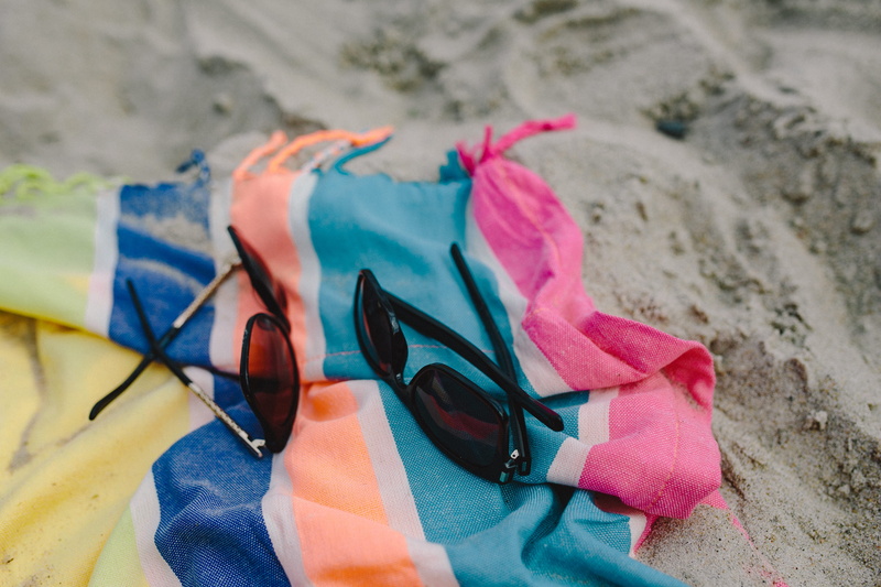 nature, selective focus, outdoors, no people, focus on foreground, sea, close-up, land, water, towel, personal accessory, clothing, shoe, sandal, holiday