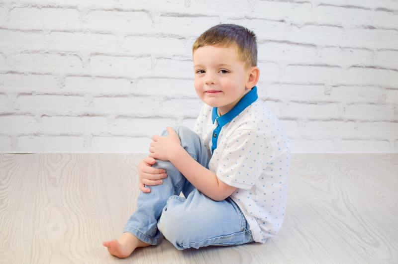 Child, polo, blue, sitting, wall - building feature, shirt, play, little, men, smile, playing, brown, real people, innocence, kindergarten, male, polka