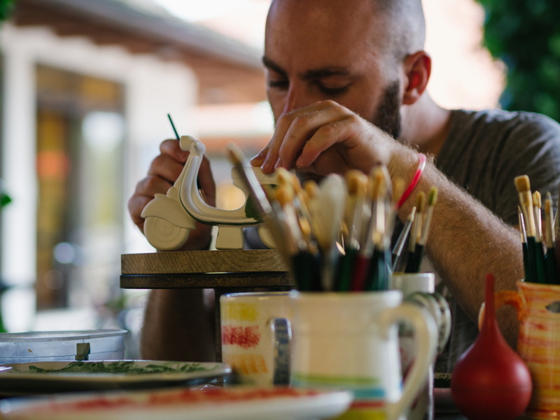 indoors, oilpainting, workbench, one person, 4K, workshop, selective focus, holding, portrait, painter, creativity, preparation, accuracy, headshot, front view