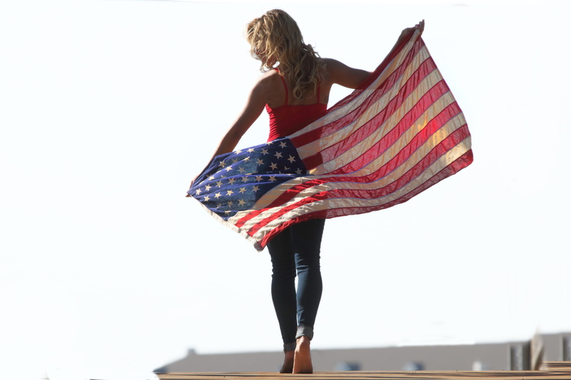 one person, blue, blonde, day, women, memorial day, beautiful woman, copy space, real people, sky, july 4th, nature, america, hairstyle, striped, usa, people