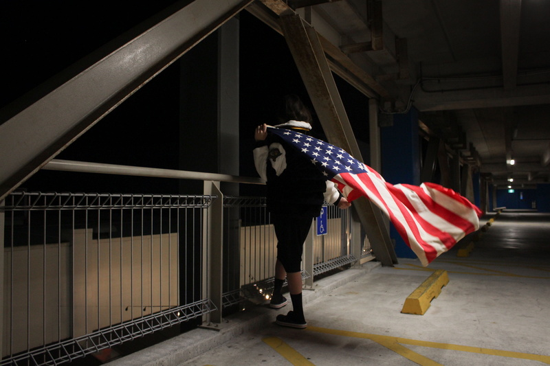 fashion, side view, transportation, one person, america, leisure activity, flag, carpark, full length, railing, motion, architecture, 4K, patriot, holding
