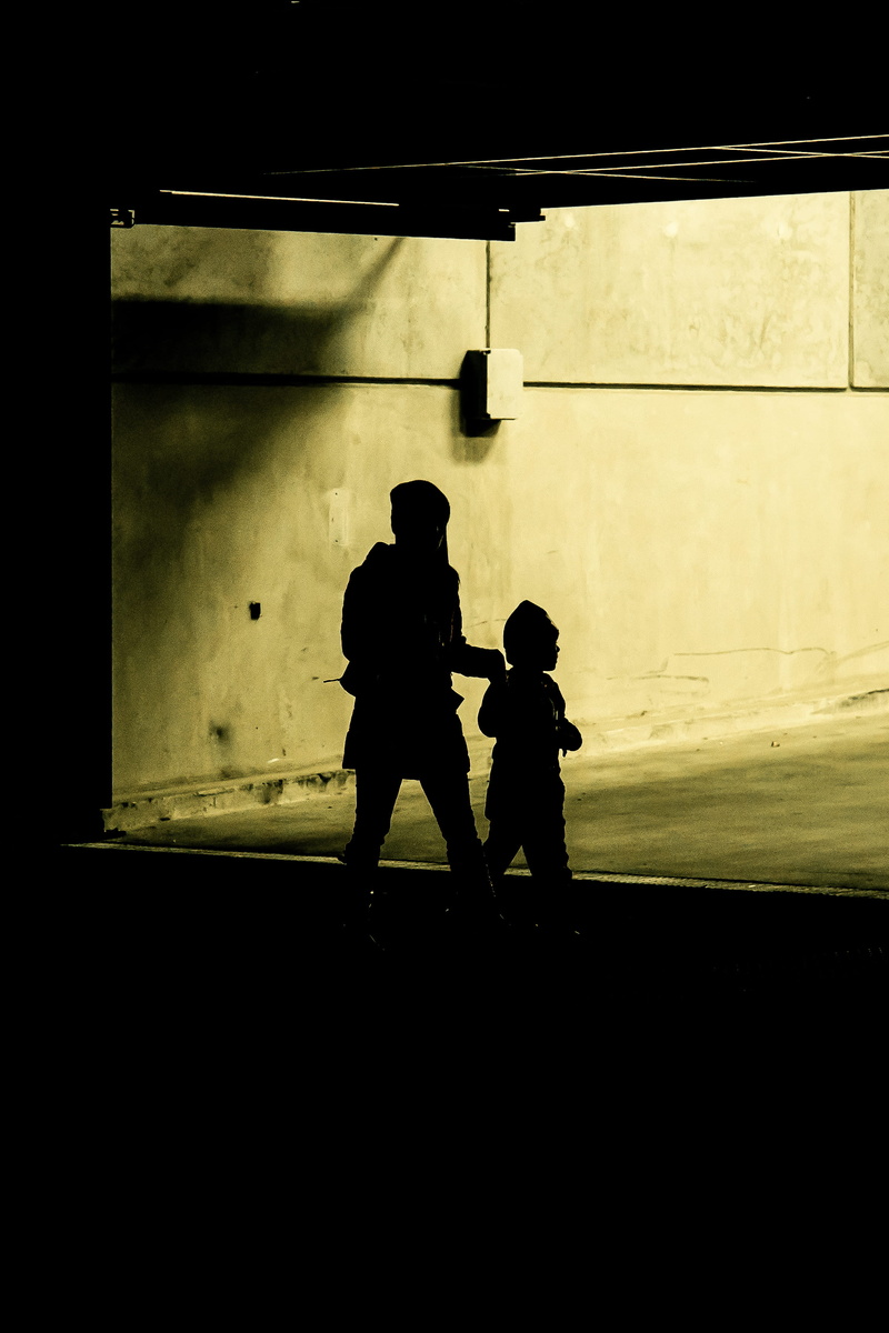 urban folk, full length, son, silhouette, real people, females, urban, males, love, built structure, carpark, street life, street portrait, cityscape, mother
