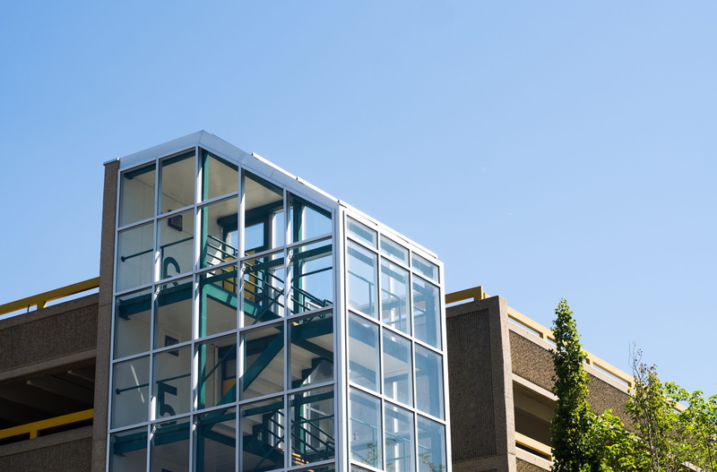 built structure, day, clear sky, copy space, building feature, symmetry, blue, office building exterior, building exterior, green, sunlight, apartment