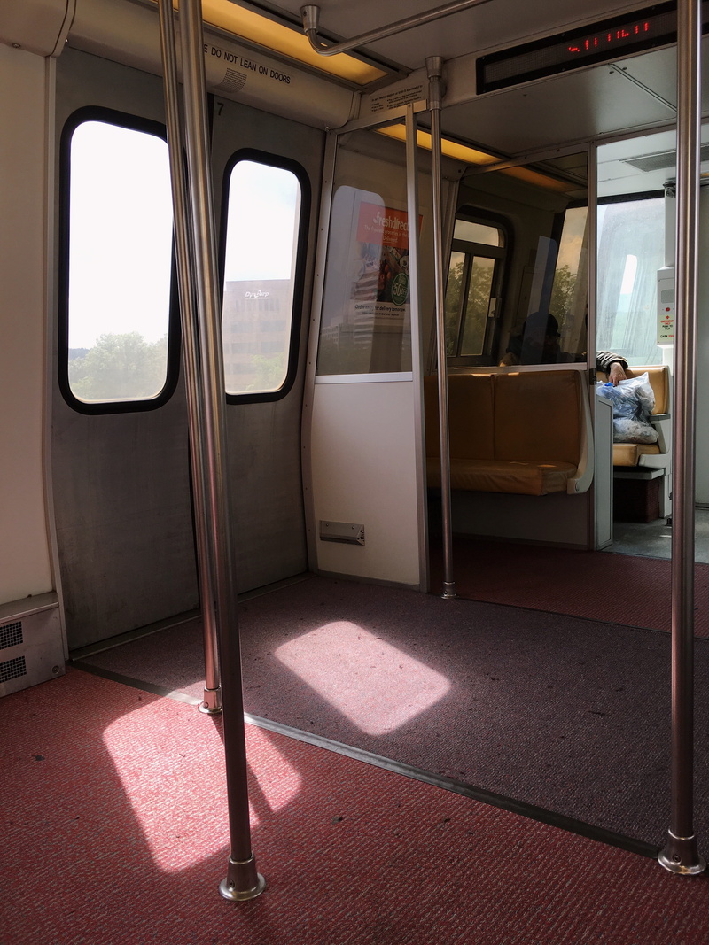outdoors, empty, sunlight, turned, vehicle seat, glass - material, metro, carpet, absence, window, rail transportation, mode of transportation, inside