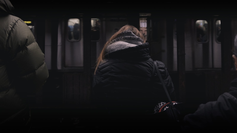 person, door, dark, white, lifestyles, warm clothing, sitting, hood, underground, adult, rear view, architecture, panel, clothing, station, woman, hood - clothing