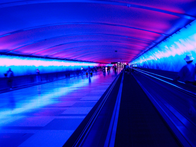 real people, men, airport, motion, travel, illuminated, subway, transportation, indoors, blue, group of people, moving walkway, incidental people, public transportation