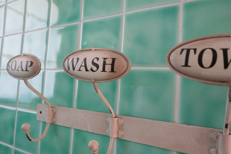 western script, close-up, sign, guidance, metal, text, architecture, washroom, script, hanging, communication, wall - building feature, information, information sign