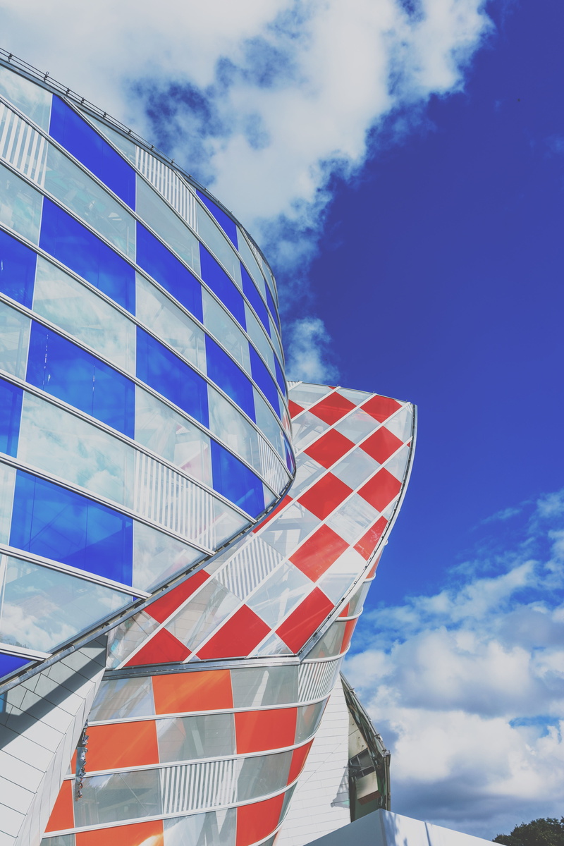 architecture, sky, france, outdoors, fondation louis vuitton, no people, blue, red, design, flag, striped, museum, low angle view, glass, cloud - sky, sunlight