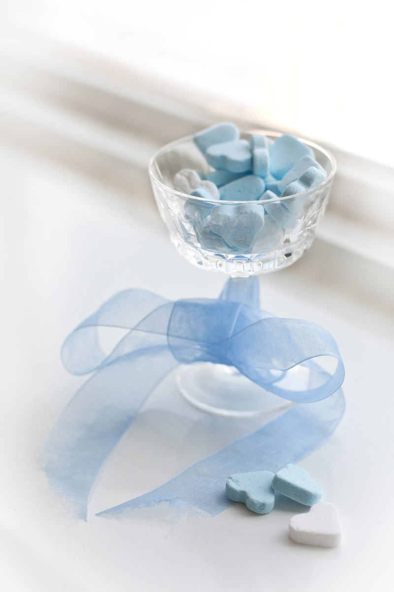 table, transparent, focus on foreground, still life, no people, treat, please, close-up, white color, blue, sweets, white heart, little boy, high angle view