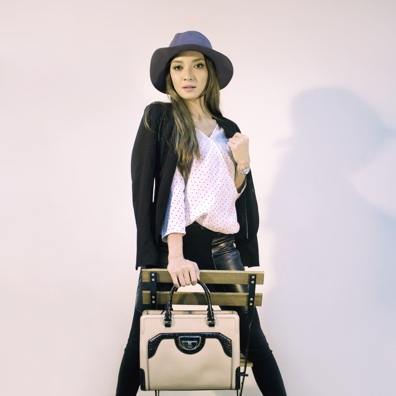 three quarter length, magazine, fashionable, jacket, holding, looking at camera, fashion, real people, handbags, front view, creative, beautiful woman