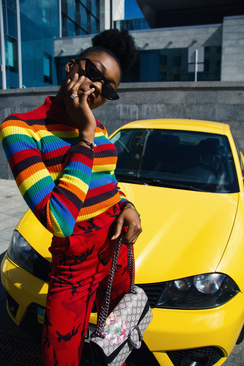 standing, lifestyles, leon, african american, men, car, black girl, wall, land vehicle, holding, nigerian, real people, daytime, transportation, rainbow colours