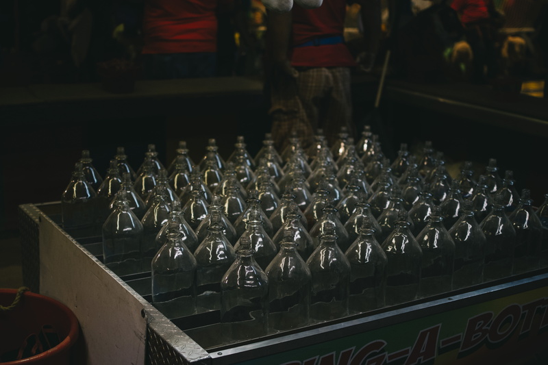 no people, communication, indoors, clear, bottles, beer bottle, arrangement, high angle view, side by side, game, glass, bar counter, fair, pub, lot, drink