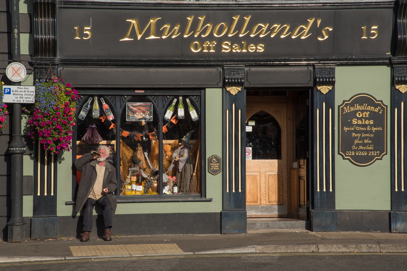 western script, booze, full length, alcohol, liquor, Alcoholism, built structure, building exterior, text, entrance, walking, Public House, retail, drink
