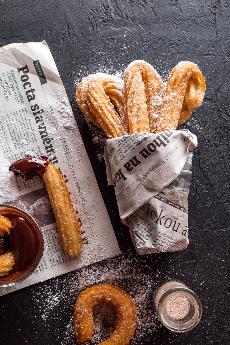 indoors, still life, freshness, newspaper, cookie, homemade, french food, pretzel, appetizer, paper, churros, cooking, close-up, bake, sweet food, coffee