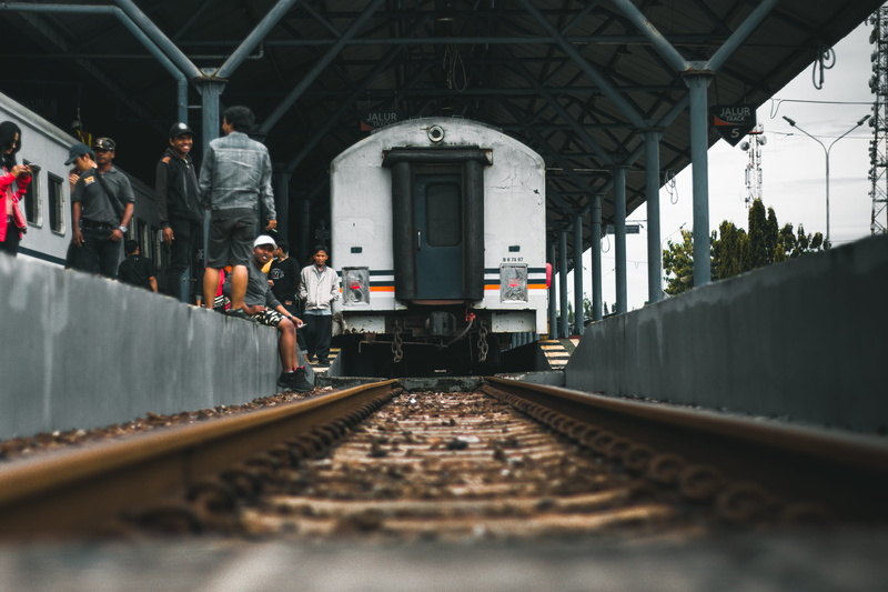 real people, focus, passenger train, architecture, transportation, built structure, metal, line, passenger car, shunting yard, railway, sitting, person
