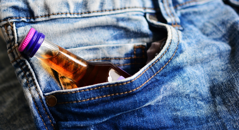 human body part, alcoholics, relaxation, textile, midsection, alcohol, close-up, bottle, one person, alcohol abuse, human limb, indoors, blue, denim, fashion