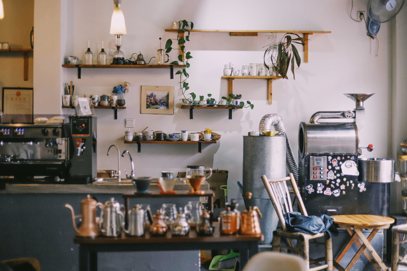 chair, bar, coffee maker, kitchen, indoors, beside, domestic kitchen, container, cafe, variation, large group of objects, flask, business, food and drink