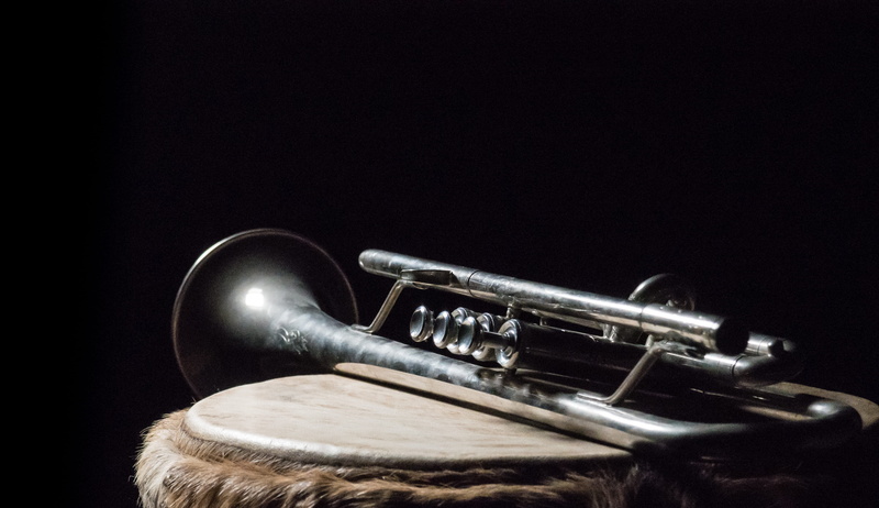 photography, 4K, metal, brass, wooden stool, stage, close-up, cut out, trumpet, music, laying, black background, copy space, no people, brown, noise, performance